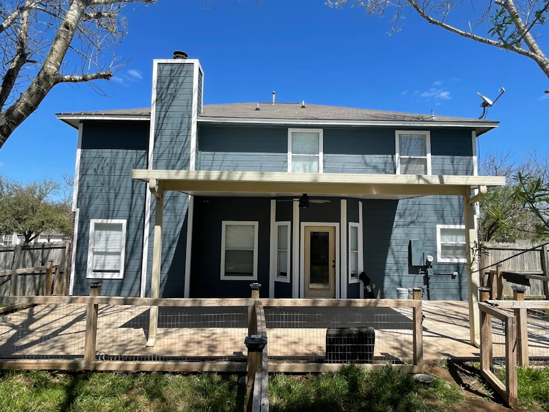 Two-story house with fresh blue siding and a wooden deck